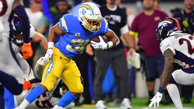 Oct 17, 2022; Inglewood, California, USA; Los Angeles Chargers running back Austin Ekeler (30) runs the ball against Denver Broncos safety Kareem Jackson (22) during the first half at SoFi Stadium.